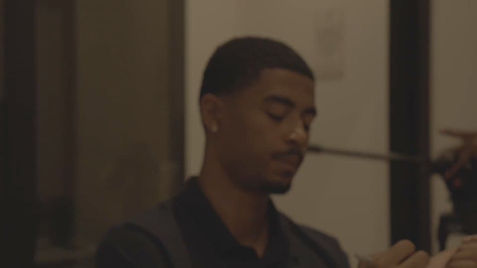Justin Cofield at work at night, a camera stand behind him